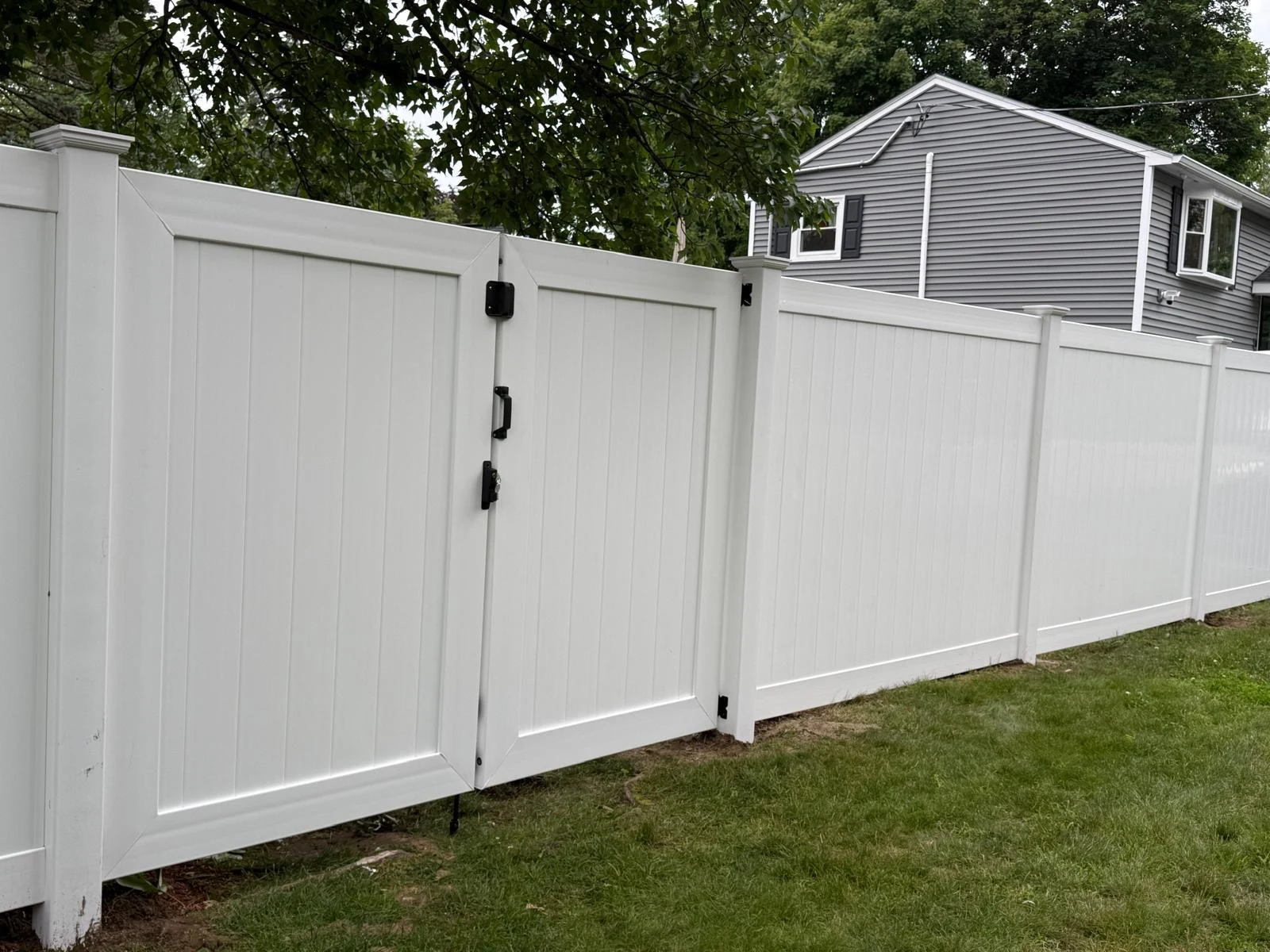 White vinyl privacy fence with a double gate
